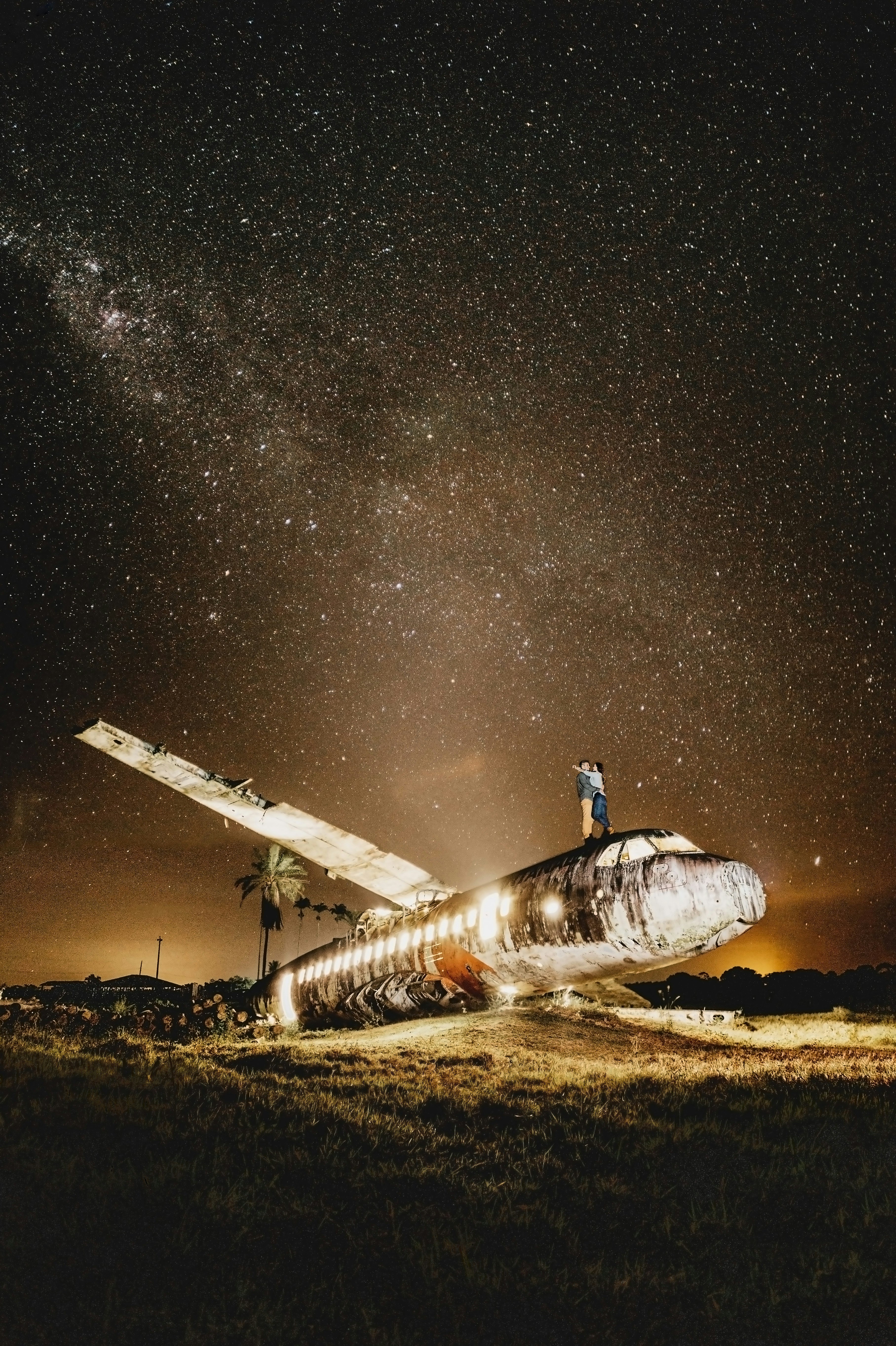 white and blue space ship on brown field under starry night